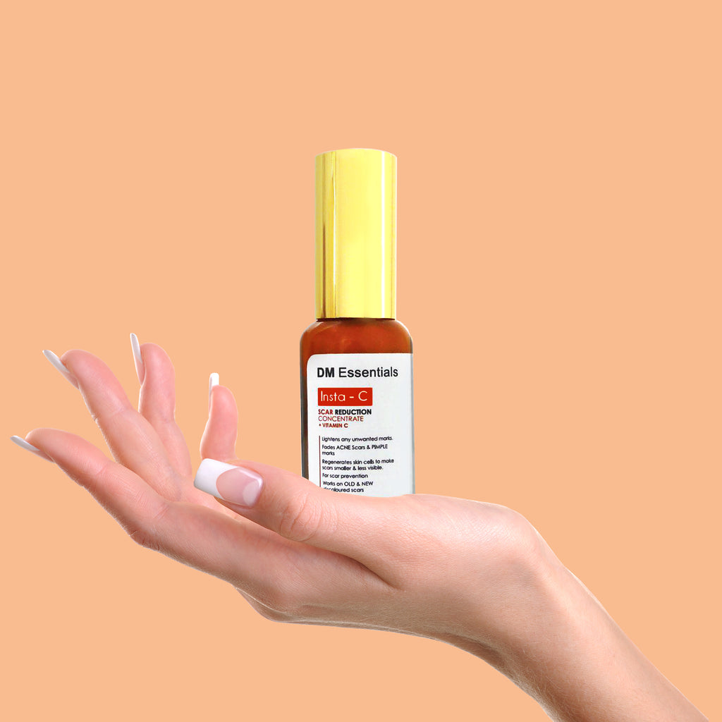 Female hand holding Insta-C Scar serum